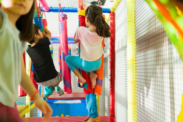 istock Active funny children playing together in the playground 1570526989