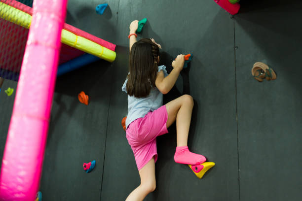 istock Beautiful child enjoying her recreation time rock climbing 1570528048