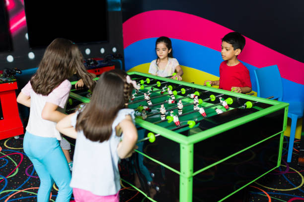 istock Excited kids having fun playing in the arcade playroom 1570537151