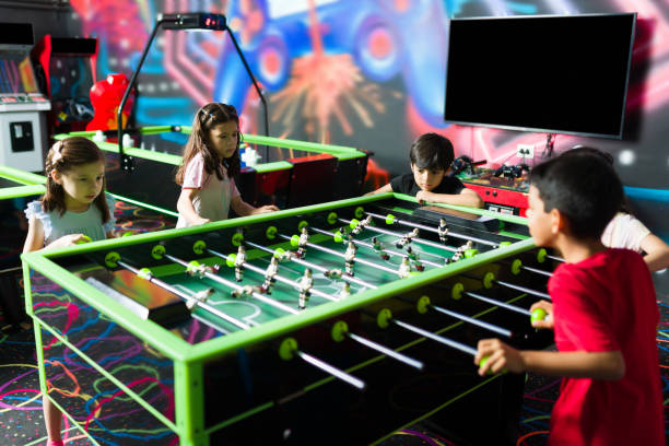 istock Cheerful kids having an arcade competition and laughing 1570537157