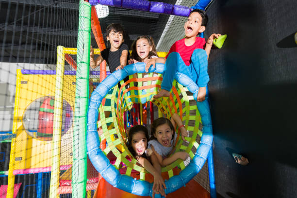istock Smiling kids playing together in the fun playground 1570537663