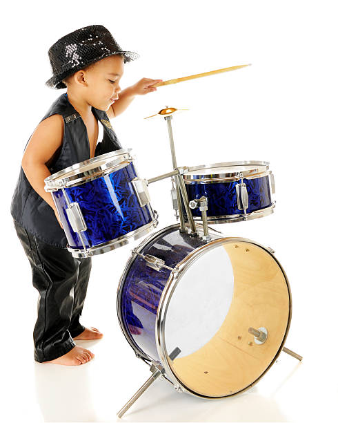 Rockin' Drummer Profile of an adorable preschooler playing the drums in his sparkly fedora and black leather vest and pants.  Barefoot.  On a white background. bass drum photos stock pictures, royalty-free photos & images
