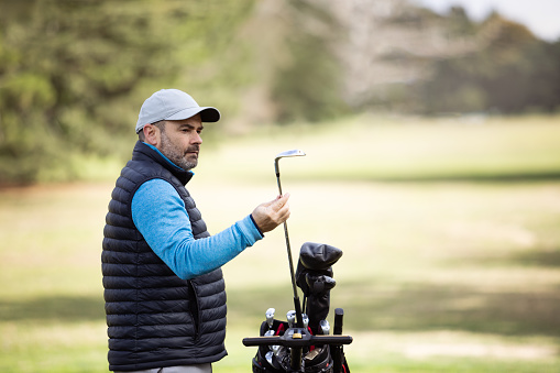 Overweight adult man playing golf in autumn - Buenos Aires - Argentina