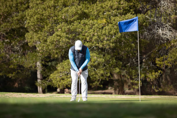 Adult man playing golf in autumn stock photo