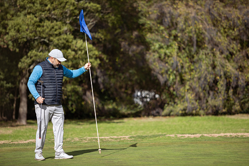 Overweight adult man playing golf in autumn - Buenos Aires - Argentina