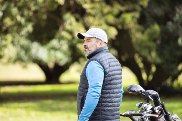 Adult man playing golf in autumn stock photo