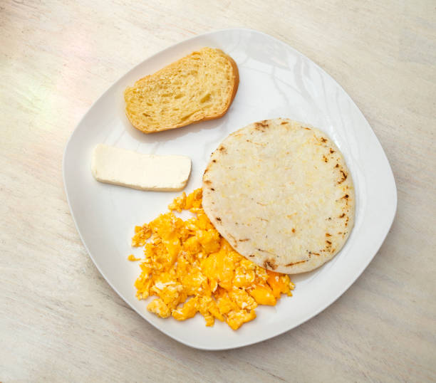 istock Traditional Colombian breakfast - Arepa with cheese, egg and bread 1570593354