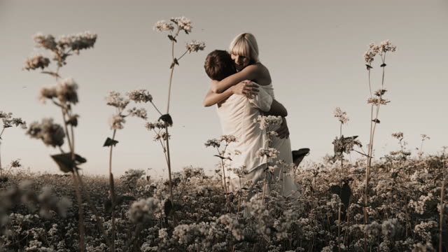 HD SLOW-MOTION: Loving Couple Twirling In Buckwheat Field