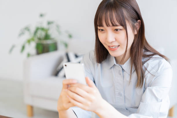 istock attractive Asian woman using a smart phone 1570599870