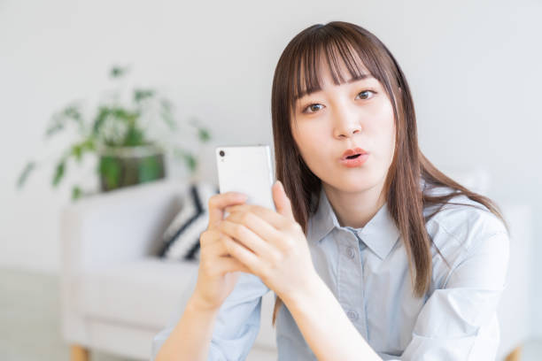 istock attractive Asian woman using a smart phone 1570600405