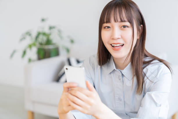 istock attractive Asian woman using a smart phone 1570601453