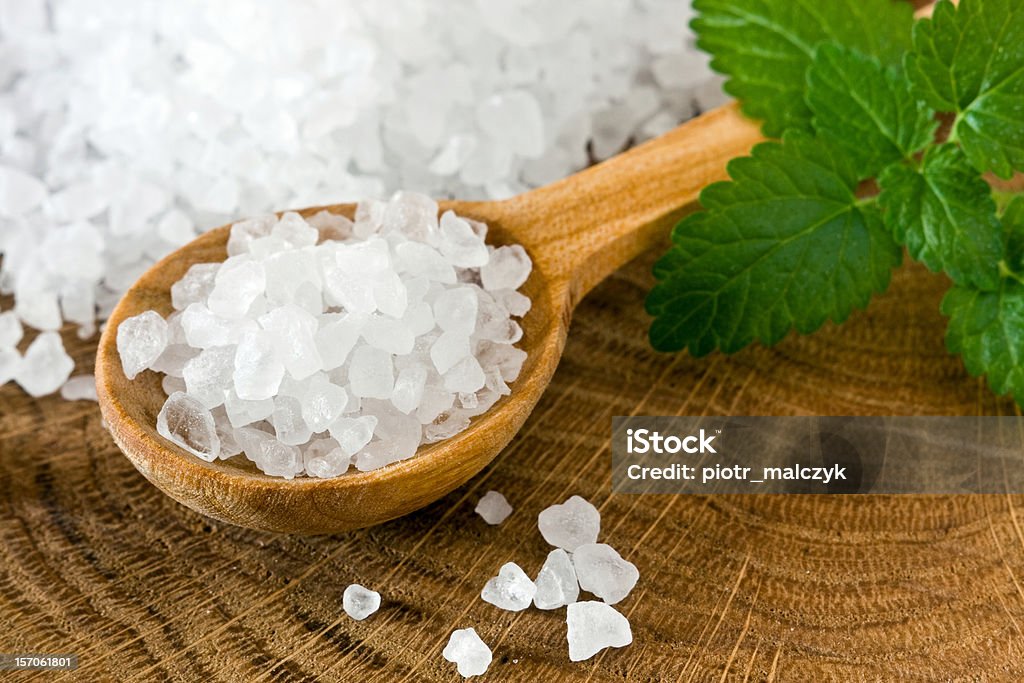Sea salt Healthy sea salt on wooden spoon closeup Brown Stock Photo