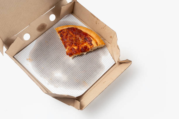 istock Margherita pizza with a slice isolated on a cardboard open box. top view 1570630201