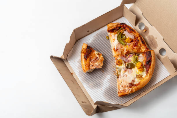 istock Two different leftover pizza in open cardboard box isolated on white background. top view 1570635889