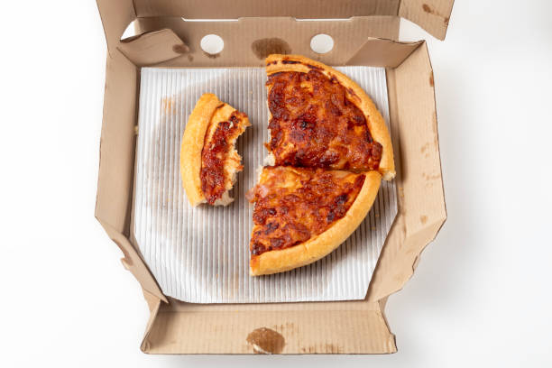istock Leftover margherita pizza in an open cardboard pizza box isolated on white background. Top view 1570638557