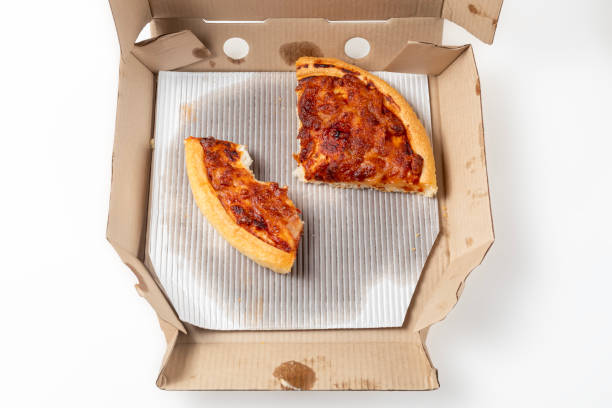 istock Leftover margherita pizza in an open cardboard pizza box. Top view 1570639091