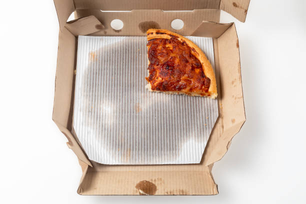 istock Margherita pizza with a slice isolated on a cardboard open box. top view 1570639603