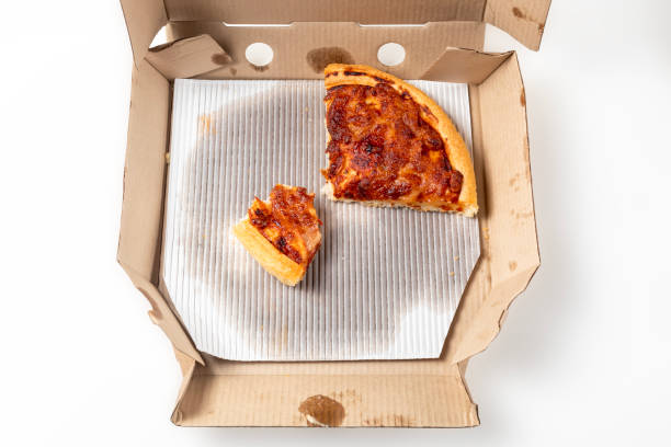 istock Leftover pizza in an open cardboard pizza box. Top view 1570639604