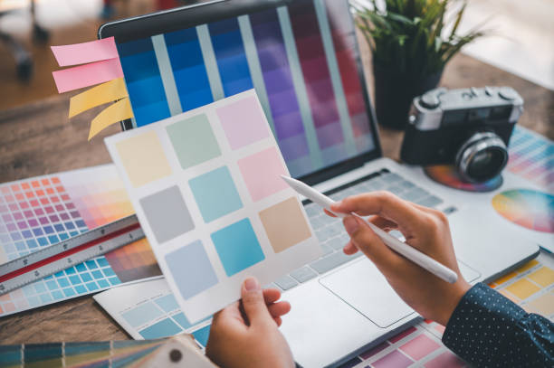 istock Graphic designer architects who work with laptops and color comparison tables for design work. 1570664131