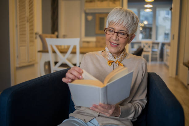 istock Woman relaxing and reading a book 1570670538