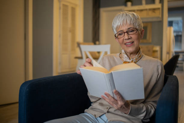 istock Woman relaxing and reading a book 1570670555