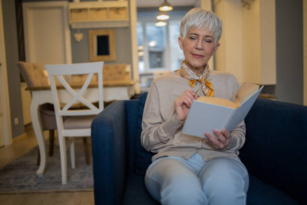 istock Woman relaxing and reading a book 1570670875