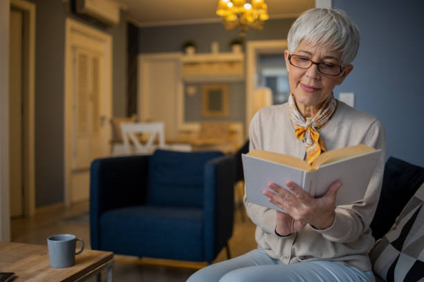 istock Woman relaxing and reading a book 1570671052