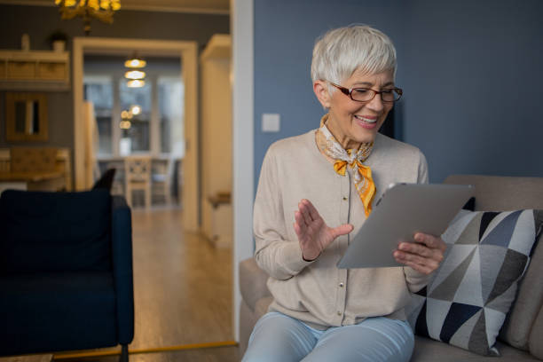 istock Happy senior woman using digital tablet 1570672125