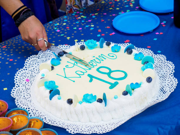 istock eighteen year old youngster birthday cake cutting 1570686586