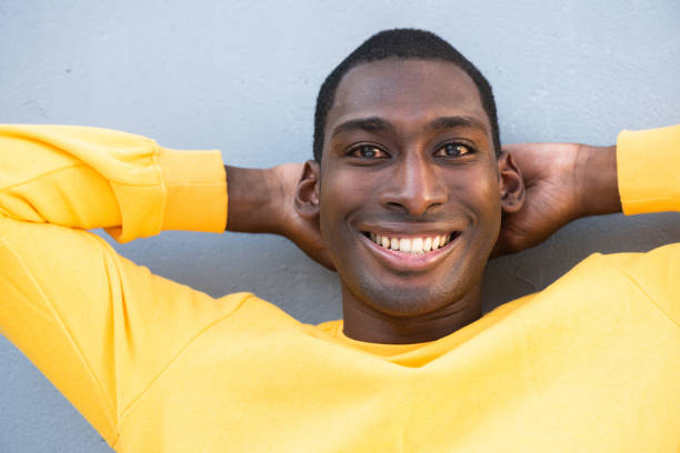 istock Close up happy young African American man with hands behind head 1570687663