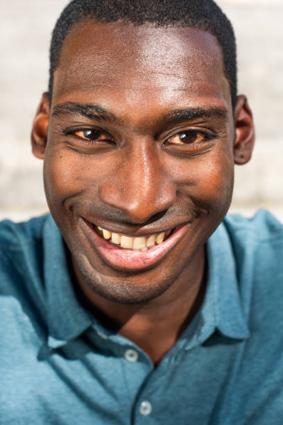 istock vertical front portrait young African American man smiling and looking at camera 1570687700