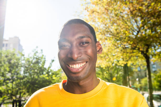 istock Close up smiling young black man outdoors 1570688230