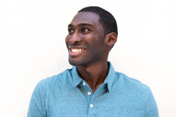 istock horizontal portrait smiling young black man against isolated white background looking away 1570688262