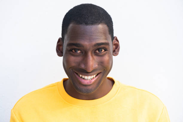 istock Close up smiling young black man against white background 1570688802