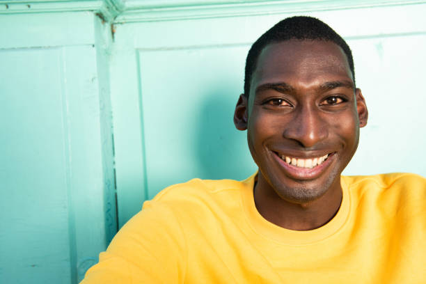 istock Close up smiling handsome young black man. 1570688818