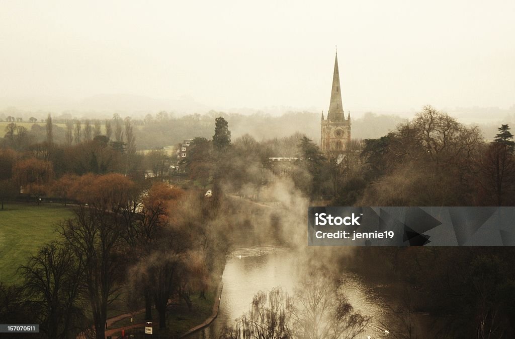 Misty View Over Stratford-upon-Avon Misty view over Stratford-upon-Avon, featuing the river Avon and Holy Trinity Church. Town Stock Photo