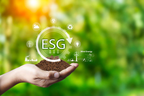 istock Net zero 2050 concept. Hand holding with green tree energy, Wind energy system icon on blur green leaf background. Wind energy for eco green. Green natural background with energy icon around it. 1570714108