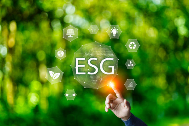 istock Net zero 2050 ESG concept, Hand with green world, wind energy system icon on blurred green leaf background. wind energy for green environment. Businessman background with energy icons around 1570714659