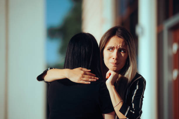 istock Woman Hugging her Friend Having Mixed Feelings About Her 1570715177