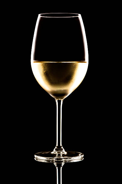 White Wine Glass on Black White Wine Glass on Black  chardonnay grape stock pictures, royalty-free photos & images