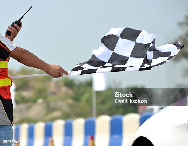 Checkered Racing Flag Being Shown To Start The Race Stock Photo - Download Image Now