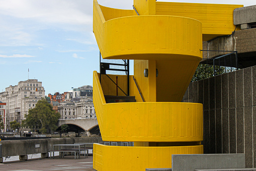 A yellow outdoor staircase on side of a building