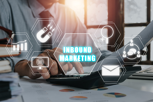 Inbound marketing concept, Businessman discussing business data on office desk with inbound marketing icon on virtual screen.