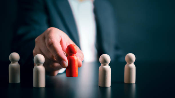Businessman hand placing reposition red wooden doll success leader unleashing power teamwork corporate strategy unlocking potential thriving unique competitive business environment background concept. stock photo