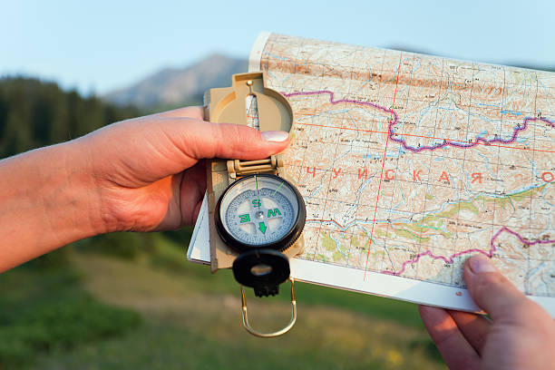 istock Tourist's hand with map and compass in mountains Switzerland 157074950