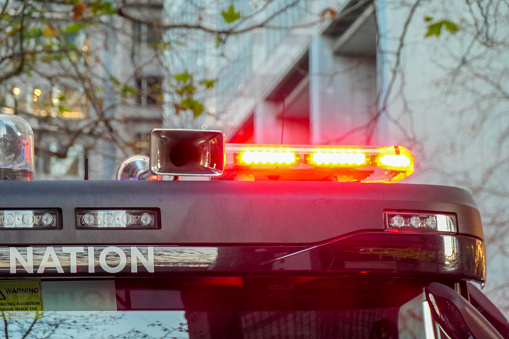 Emergency red lights on the front of a fire truck of the New South Wales Fire Brigade parked in Phillip Street in the central business district of Sydney.  The word 