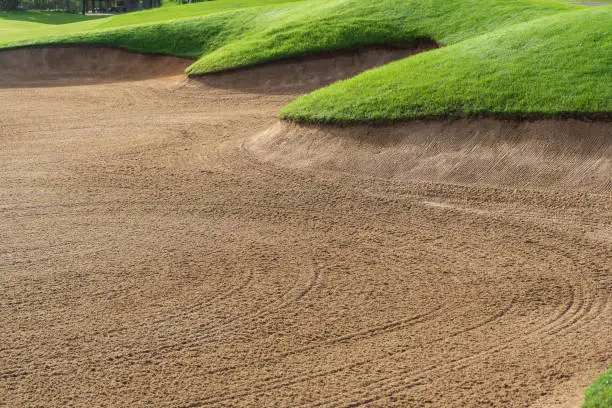 Golf Course Sand Pit Bunkers, green grass surrounding the beautiful sand holes is one of the most challenging obstacles for golfers and adds to the beauty of the golf course..