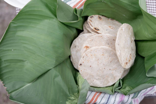 Traditional fresh cooked corn tortillas covered with banana leaves in Guatemala