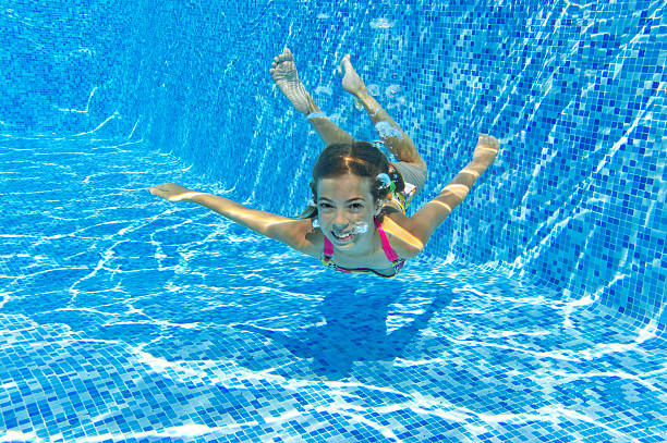 istock Happy smiling underwater child in swimming pool 157079320