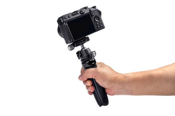 istock Human hand holding tripod with camera 1570901275